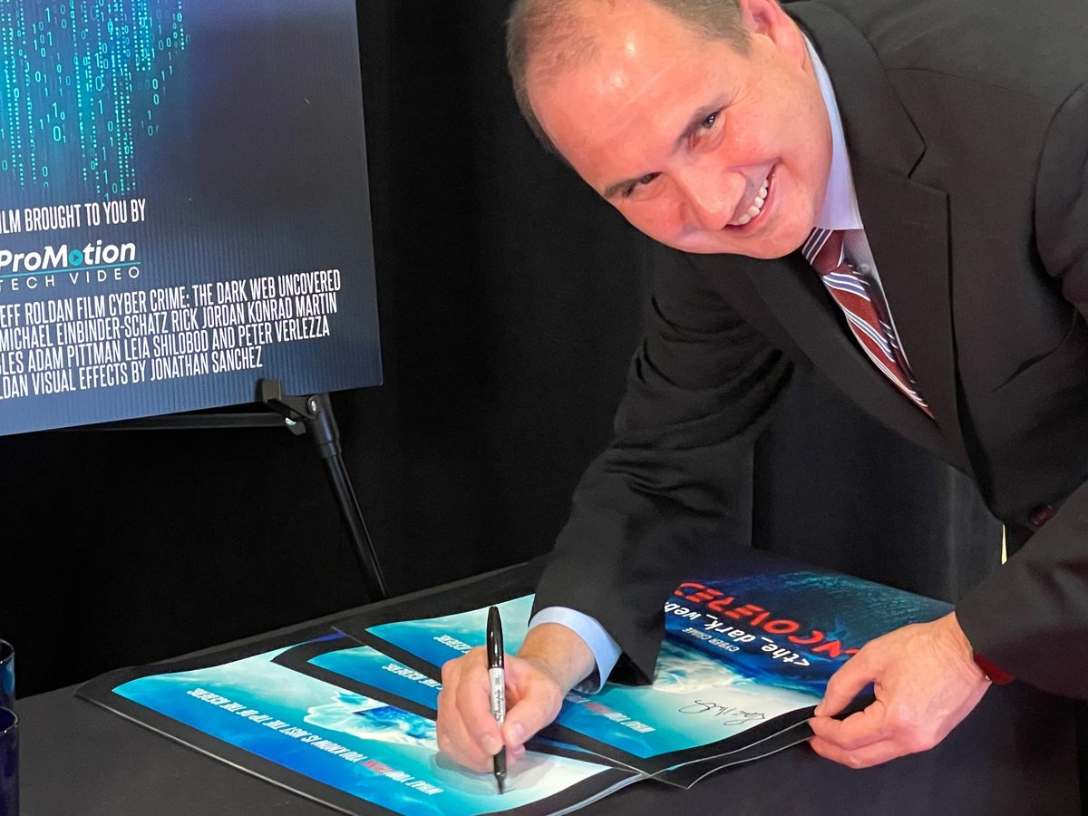 Rene signing Cyber Crime posters